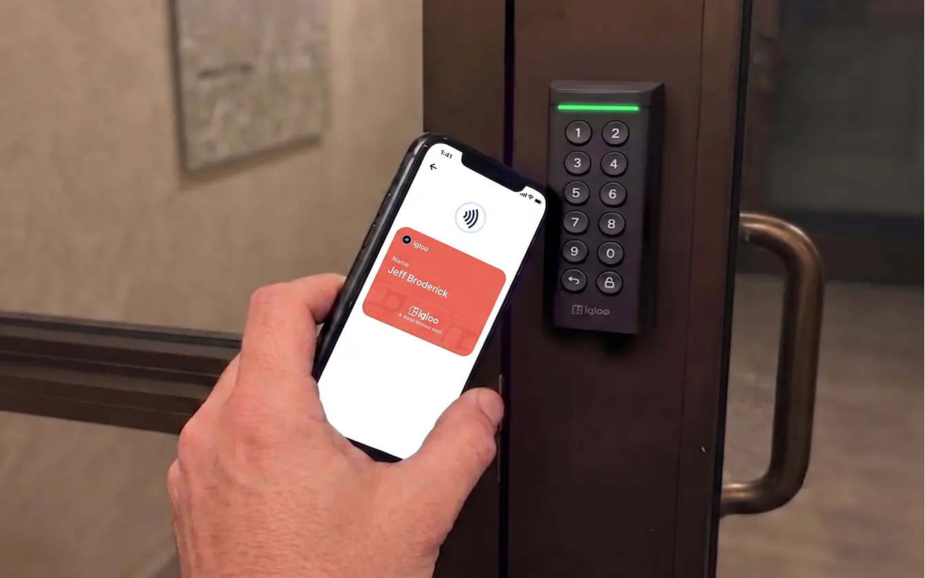 Common access — resident unlocking a lobby door with a mobile wallet key